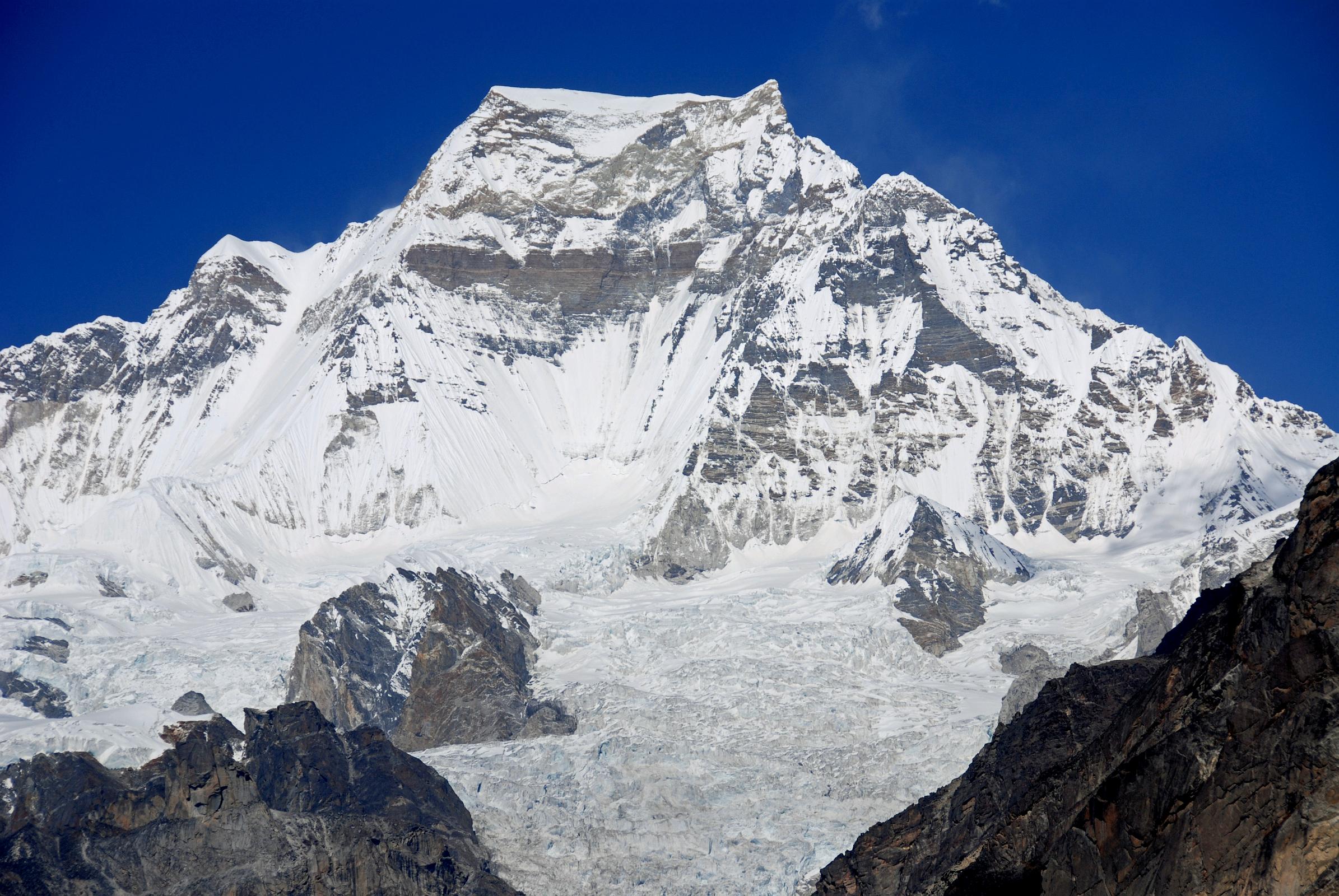 06 Gokyo 3 5 Gyachung Kang Close Up From Near Gokyo Gyachung Kang (7952m) shines bright white in the late morning sun from the terminal moraine of the Nguzumpa Glacier from beyond Gokyo.